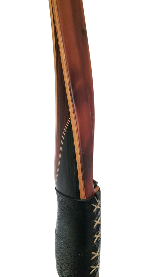 Close-up of a wooden object with a black leather case on a white background
